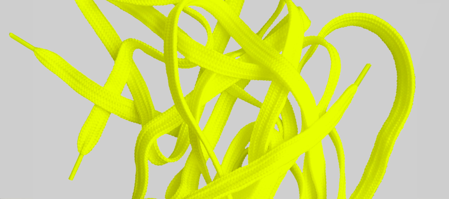 Yellow shoelaces on a gray background.